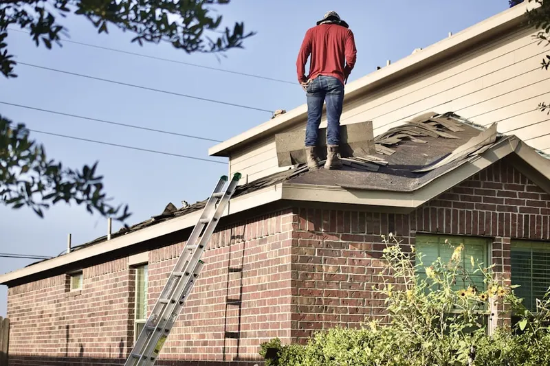 Professional roofer working on a residential roof in Albany